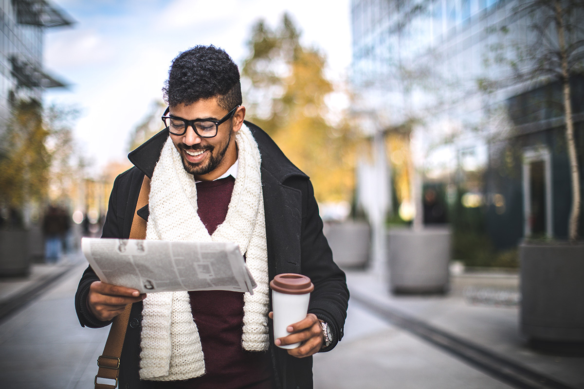 Man reading newspaper on the street