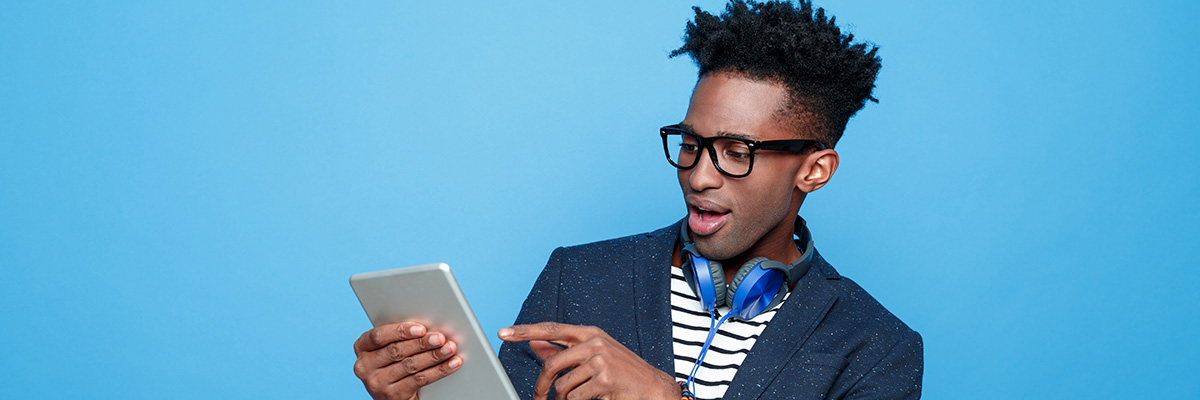https://www.nielsen.com/wp-content/uploads/sites/2/2022/10/young-black-male-with-tablet-headphones-full-width.jpg